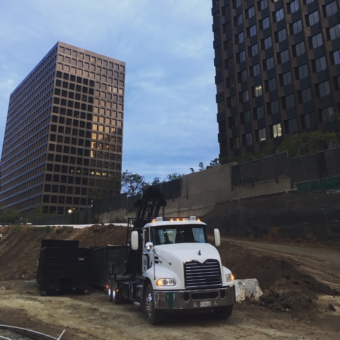 JD Roll Off Dumpsters container placed at a downtown high-rise construction site