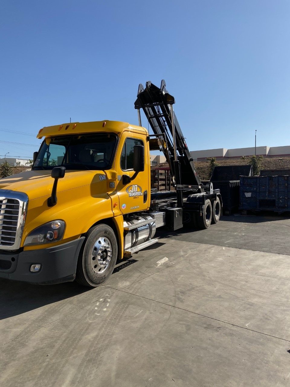 Yellow JD Transport Freightliner roll-off truck